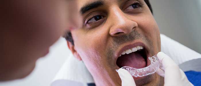 dentist assisting patient wear invisible braces